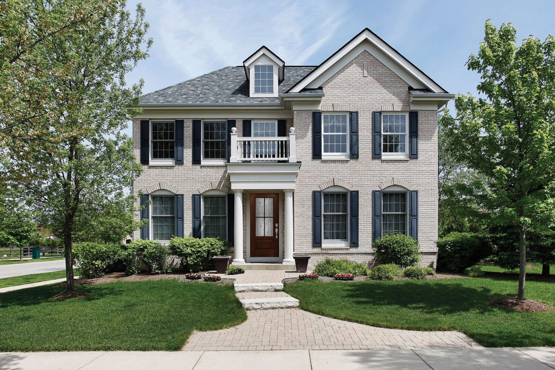 his Colonial-style home features a Timbergrain Fiberglass Exterior Door in Cherry, with a 3/4 Lite, 2 Panels door style and SDL glass, and Schlage Century hardware with Encode Deadbolt in Satin Nickel.